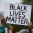 person holding up "Black Lives Matter" sign