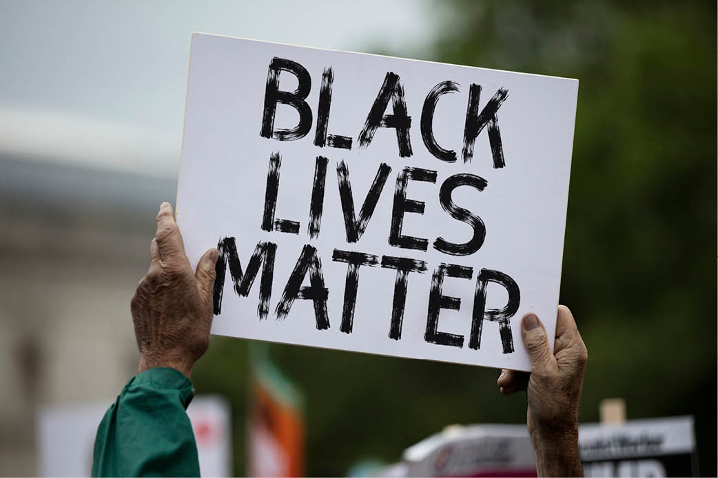 Music's Road to "Black Lives Matter" person holding up "Black Lives Matter" sign