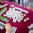 People at a table playing Mahjongg