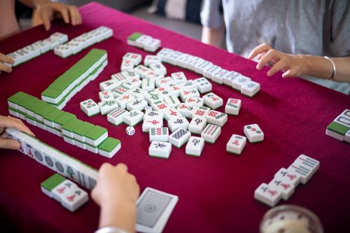 People at a table playing Mahjongg