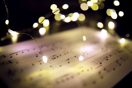 Image of music score with stage lights around it