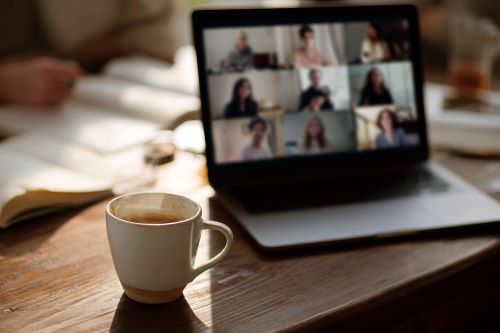 Coffee cup next to a Zoom screen